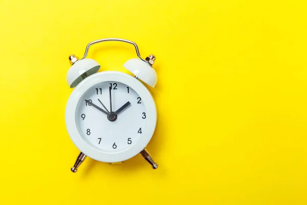 Vintage alarm clock Isolated on yellow background — Stock Photo, Image
