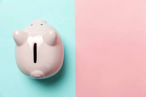 Pink piggy bank isolated on blue and pink background — Stock Photo, Image
