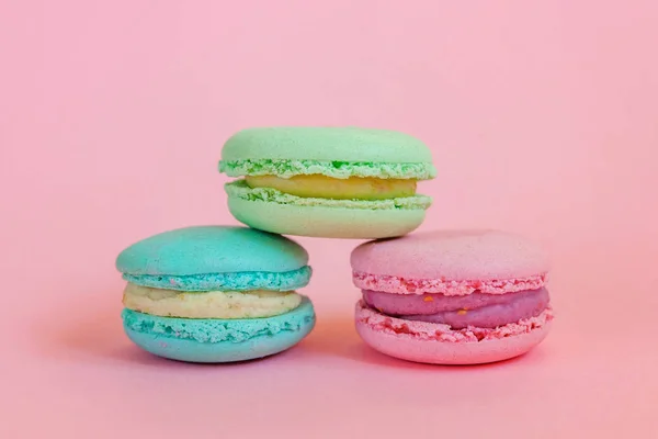 Blue pink and green macaron on pink background