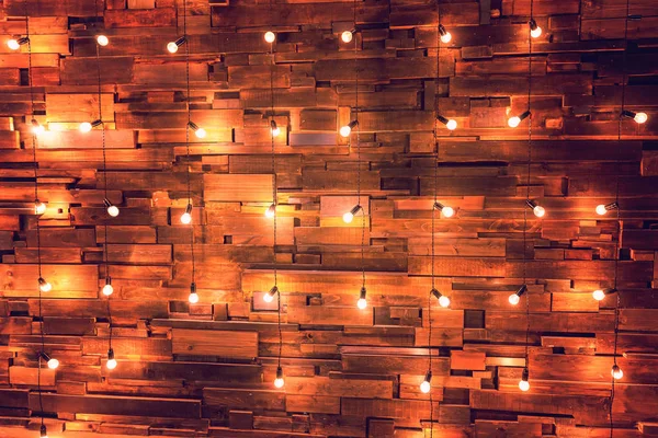 Wooden planks with lamps background. Decorated interior room with gold lights