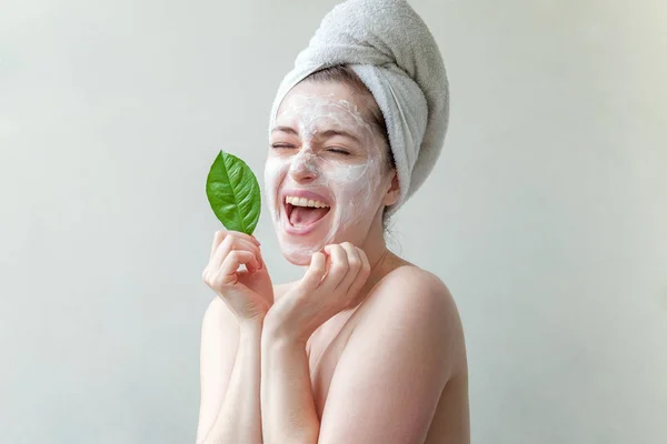 Woman face with green leaf and cream or nourishing mask — Stock Photo, Image