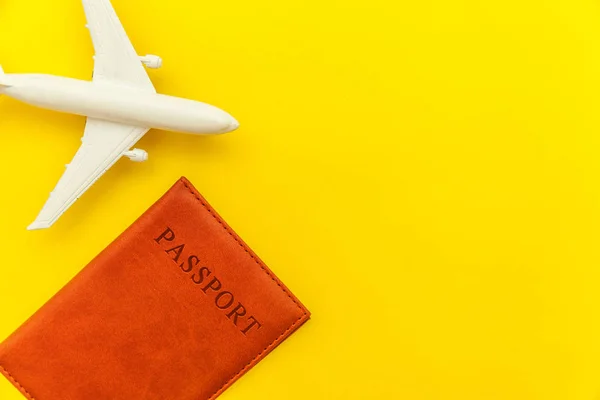 Conceito de viagem de aventura de viagem plana simples mínimo com avião e passaporte no fundo moderno da moda amarela — Fotografia de Stock