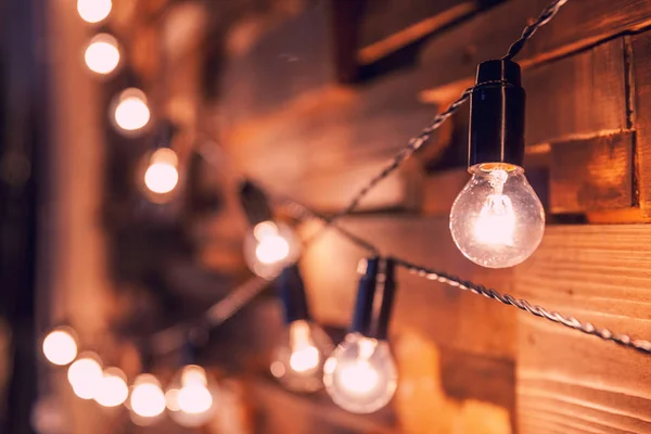 Wooden planks with lamps background. Decorated interior room with gold lights