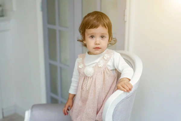 Little girl sitting on modern chair — Stock Photo, Image