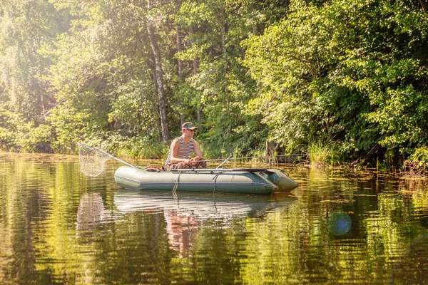 Fisherman in a boat — Stock Photo, Image