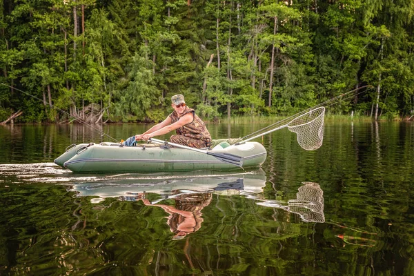 Fisherman in a boat — Stock Photo, Image