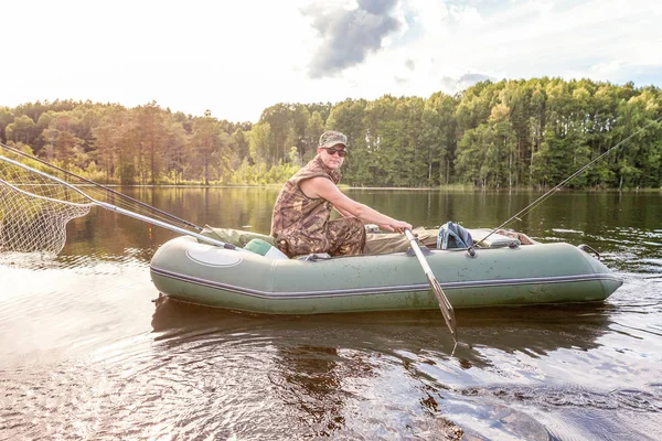 Fisherman in a boat — Stock Photo, Image