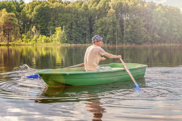 Fisherman in a boat — Stock Photo, Image