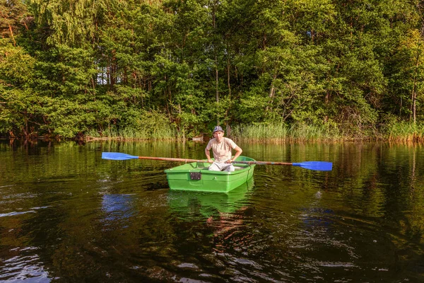 Fisherman in a boat — Stock Photo, Image