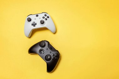 Sarı arka planda beyaz ve siyah iki joystick. Bilgisayar oyun Yarışması videogame kontrol çatışma kavramı