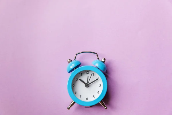 Ringing twin bell vintage classic alarm clock Isolated on purple violet pastel colourful background. Rest hours time of life good morning night wake up awake concept — Stock Photo, Image