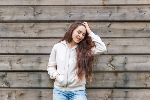 Chica feliz sonriendo. Retrato de belleza joven feliz positivo riendo morena mujer sobre fondo de pared de madera —  Fotos de Stock