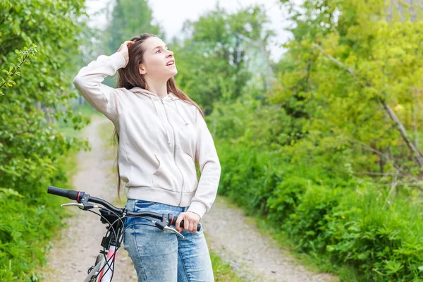 Mladá žena jezdila na kole v letním městském parku. Aktivní lidé. Hipsterová holka relaxovat a jezdit na kole — Stock fotografie