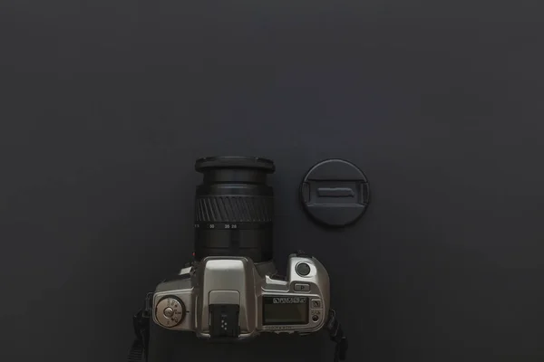 Photographer workplace with dslr camera system on dark black table background. Hobby travel photography concept — Stock Photo, Image