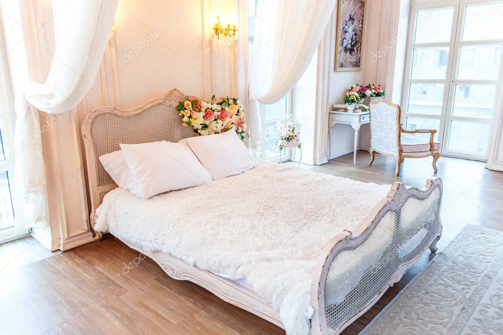 Beautiful white bright clean interior bedroom in luxurious baroque style