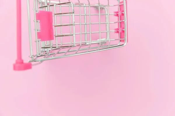 Kleine supermarkt kruidenier speelgoed push Cart geïsoleerd op roze pastel kleurrijke achtergrond — Stockfoto