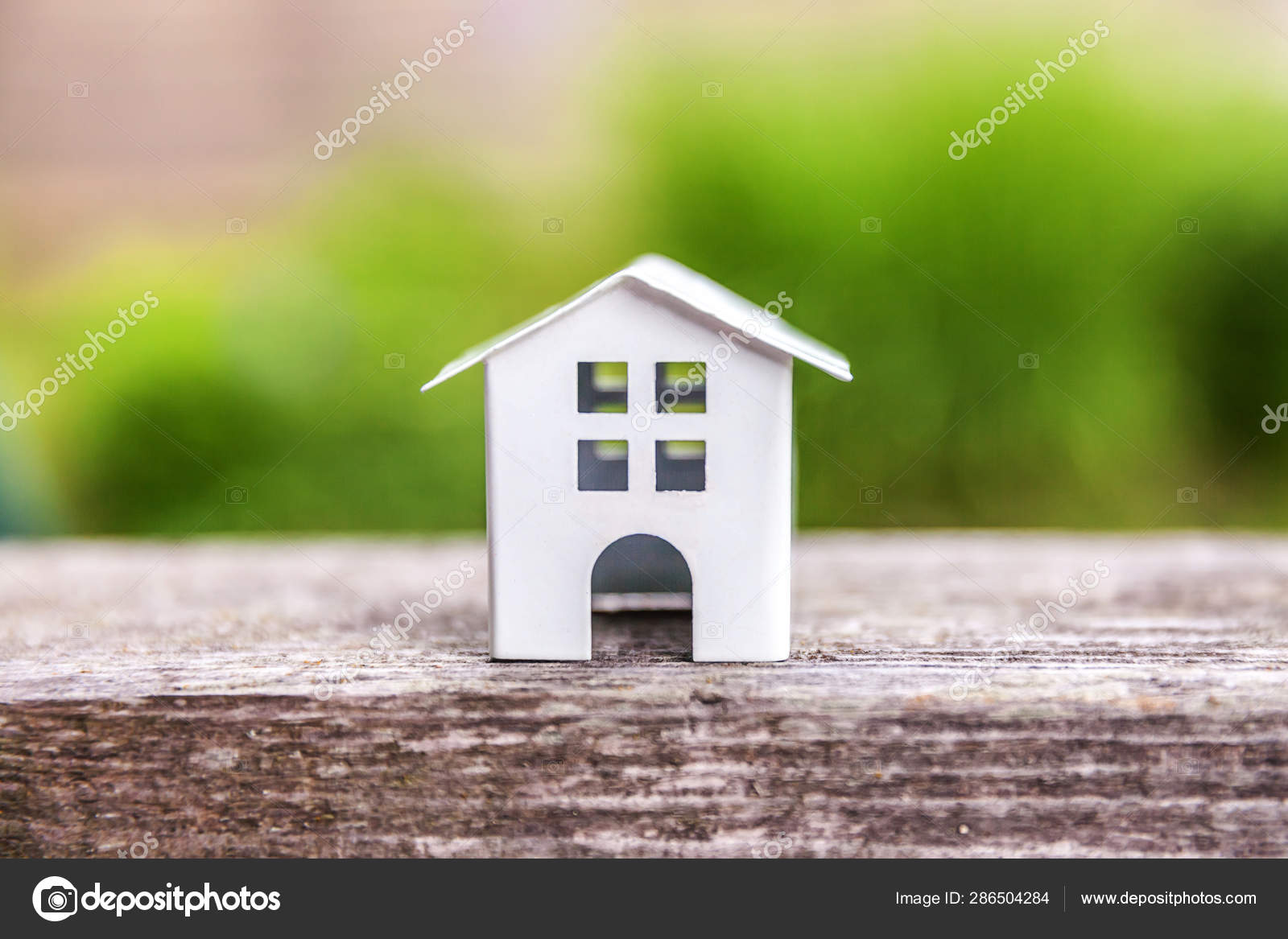 Miniature white toy model house in wooden background near green backdrop  Stock Photo by ©Luljo 286504284