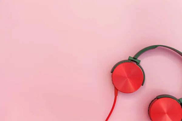 Red headphones with cable isolated on pink pastel colorful background — Stock Photo, Image