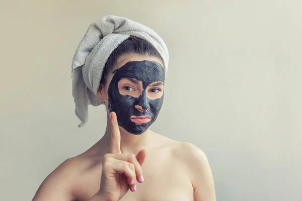 Žena použití černé výživná maska na obličej — Stock fotografie