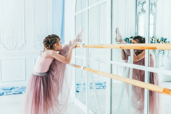 Beautiful graceful ballerina practice ballet positions in pink tutu skirt in dance class — Stock Photo, Image