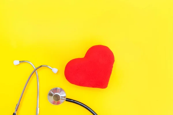 Medicine equipment stethoscope or phonendoscope and red heart isolated on trendy yellow background — Stock Photo, Image