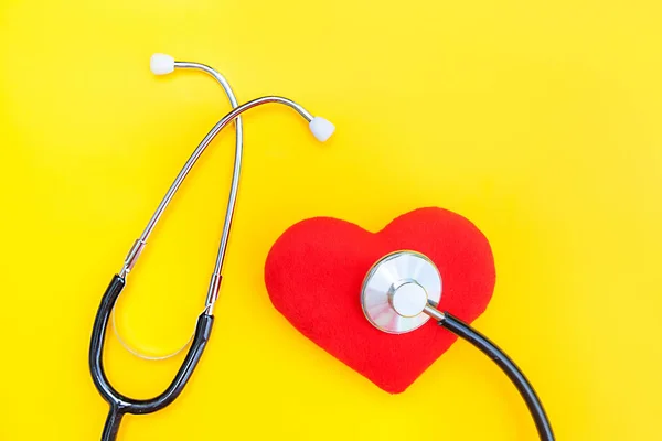Medicine equipment stethoscope or phonendoscope and red heart isolated on trendy yellow background — Stock Photo, Image