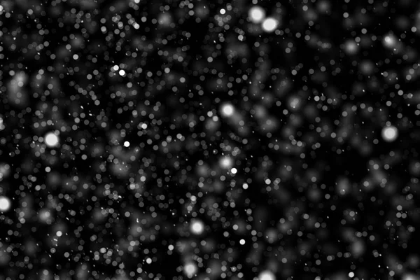 Falling down real white snowflakes on black background