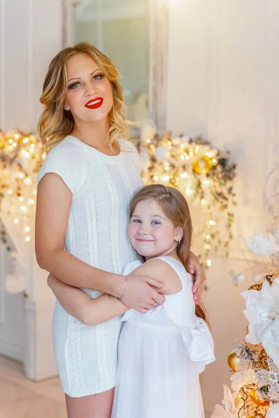 Anne ve kızı evde Noel ağacı yakınında oynarken dinlenmek