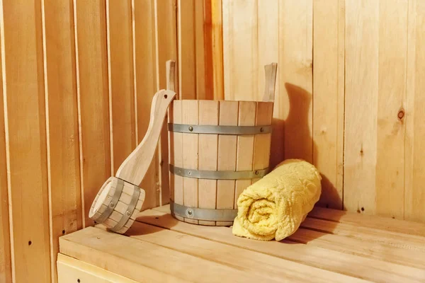 Interior details Finnish sauna steam room bathhouse with traditional sauna accessories basin scoop towel
