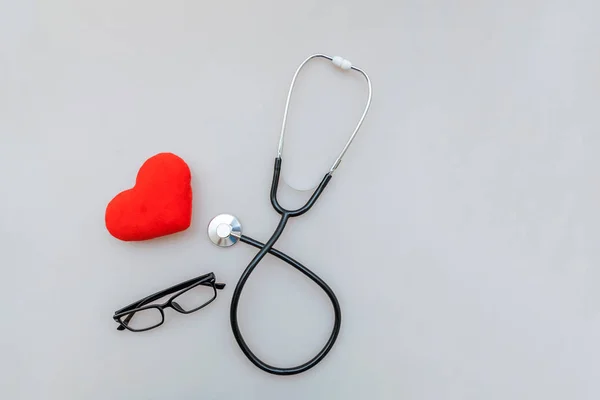 Medicine equipment stethoscope or phonendoscope glasses and red heart isolated on white background. Instrument device for doctor. Health care life insurance concept — Stock Photo, Image