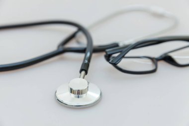 Tıbbi ekipman stetoskop veya fonndoskop ve gözlük beyaz arka plan üzerinde izole. Doktor için alet cihazı. Sağlık hayat sigortası kavramı