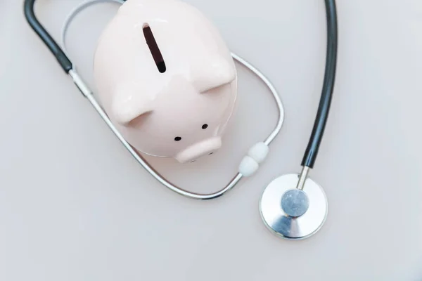 Medicina equipamento médico estetoscópio ou fonendoscópio e porquinho banco isolado em fundo branco — Fotografia de Stock