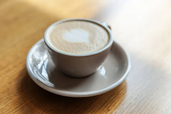 Coffee cup fresh cream organic cappuccino on table in cafe