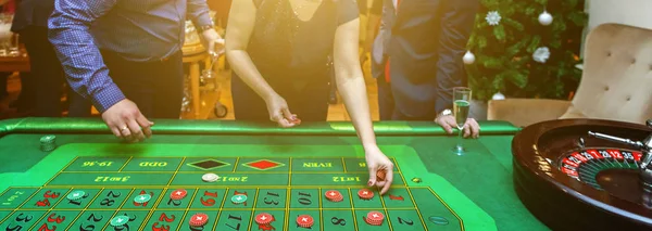 Group of people behind roulette gambling table in luxury casino banner — Stock Photo, Image