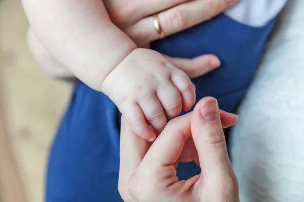 Tiny newborn infant male or female baby hand holding mother finger — Stock Photo, Image