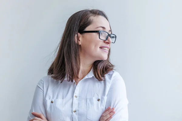 Menina feliz bonita sorrindo. Beleza retrato simples jovem mulher morena sorridente em óculos isolados no fundo branco. Emoção humana positiva expressão facial linguagem corporal. Espaço de cópia — Fotografia de Stock