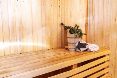 İçişleri, geleneksel sauna aksesuarları, süpürge kepçesi kepçeli şapka havlusuyla Finlandiya sauna sauna saunası detaylarını anlatıyor. Geleneksel eski Rus hamamı SPA konsepti. Rahatlayın köy banyosu konsepti