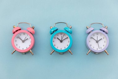 En az tasarım üç zil çalan klasik alarm saati mavi pastel arka planda izole edildi. Hayatın dinlenme saatleri. İyi sabahlar. Uyanık kalma kavramı. Düz görünüm kopyalama alanı