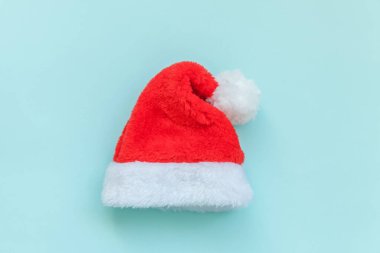 Noel Baba şapkasını mavi renkli arka planda izole etmek çok basit bir tasarım. Noel, yeni yıl kutlamaları için aralık zamanı. Düz görünüm kopyalama alanı