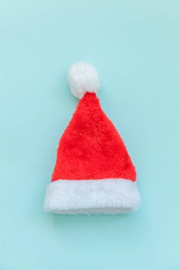 Noel Baba şapkasını mavi renkli arka planda izole etmek çok basit bir tasarım. Noel, yeni yıl kutlamaları için aralık zamanı. Düz görünüm kopyalama alanı