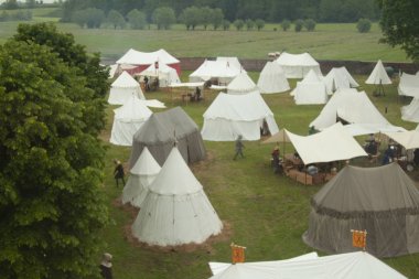military medieval camp with tents and weapons clipart