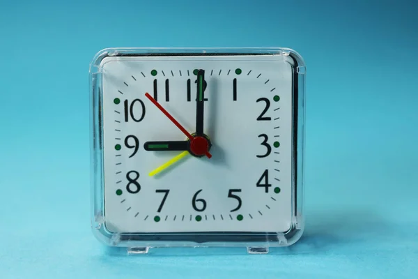 a desk clock on a tinted background.