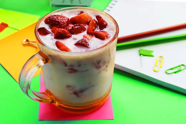 strawberry yogurt on the background of office desktop