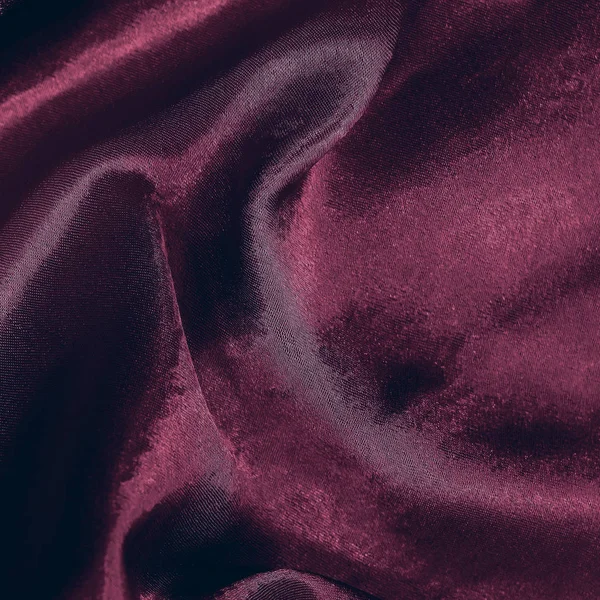 smooth folds of dark red satin fabric. silk. Satin background. toned