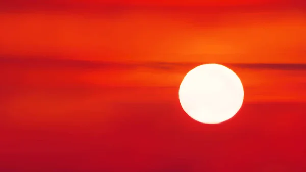 the sun against a bright red-yellow sky. sunset background.