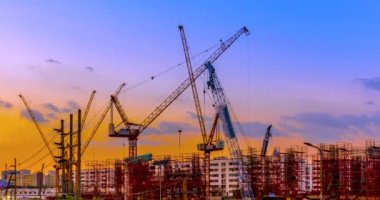 Hızlandırılmış akşam günbatımı, çalışma ve iş kurma projesi ve kalacak yer şehir geliştirme İnşaat vinçleri vardır.