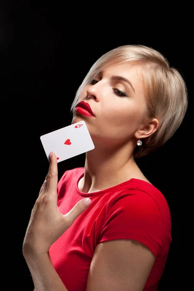 Schöne blonde Mädchen zeigt eine Pokerkarte — Stockfoto