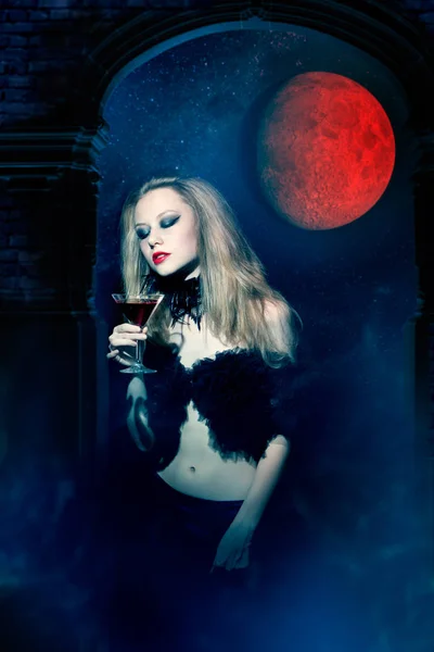 Aggressive vampire woman with glass of wine — Stock Photo, Image