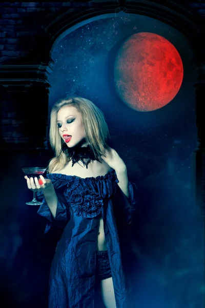 Aggressive vampire woman with glass of wine — Stock Photo, Image