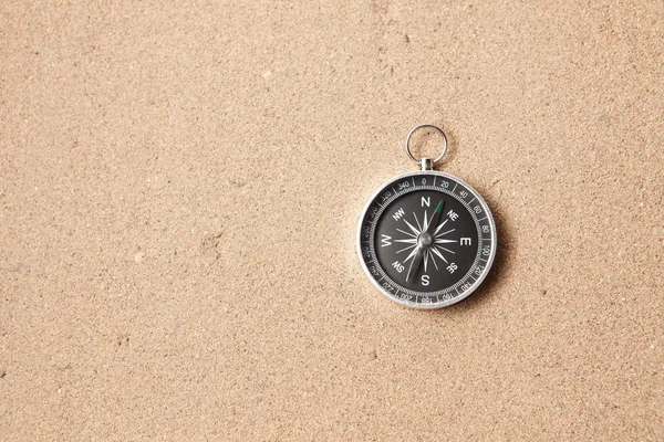 Compass on the sand and place for text — Stock Photo, Image